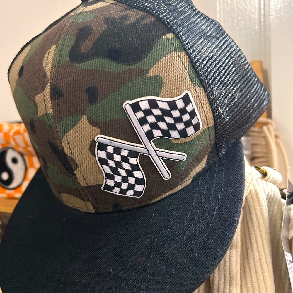 Camo snap back trucker hat with checkered flag patch